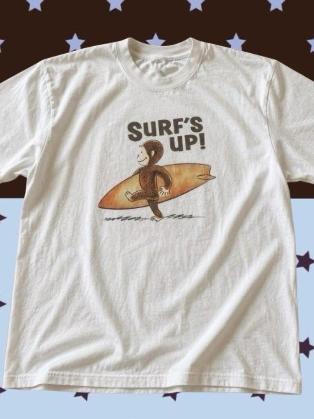 Gildan White Curious George surf shirt with graphic of a monkey ‘SURF’S UP!’